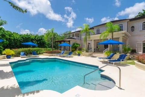 Beautiful private pool with sun beds, parasols and views over the private gardens.