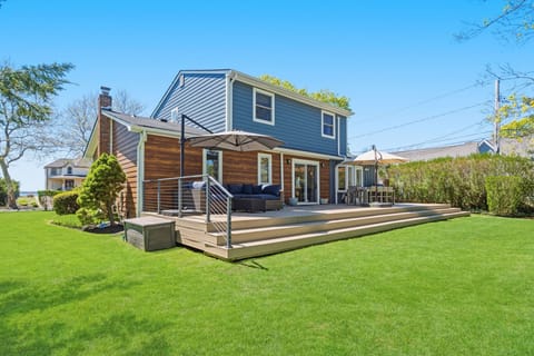 Back deck with lounge seating, dining for eight, and private yard