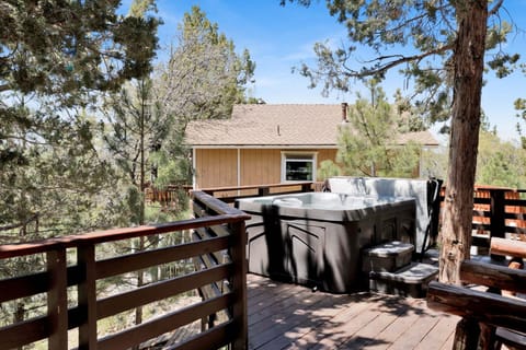 Soak in the private hot tub on the deck surrounded by towering pines and sweeping Bear Mountain views.