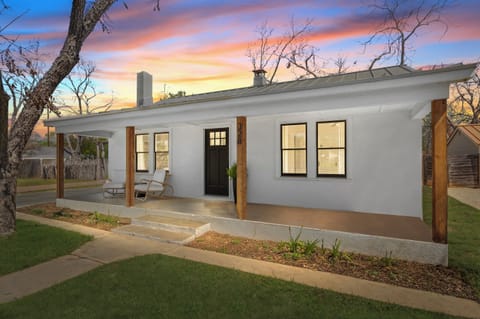 End the day beneath colorful Texas skies at this charming retreat, where the glowing front porch and peaceful setting invite you to slow down and stay awhile.