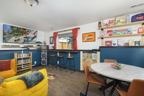 Game room including an assortment of board games, dance dance revolution on PS2, Karaoke machine, 65" tv, and a Nintendo switch with mariokart ready for the kids. 