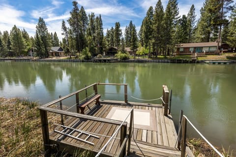 A private wooden dock sits on the deschutes river, surrounded by towering pines. Perfect for morning coffee or an afternoon of relaxation by the water.