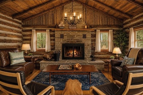     Stunning great room with soaring ceilings and a wood-burning fireplace. 