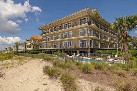 The boardwalk from the beach leads straight to the pool and condo