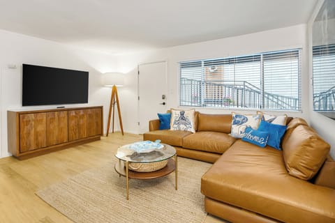 Spacious, sun-drenched living area featuring contemporary finishes and a warm, inviting atmosphere.