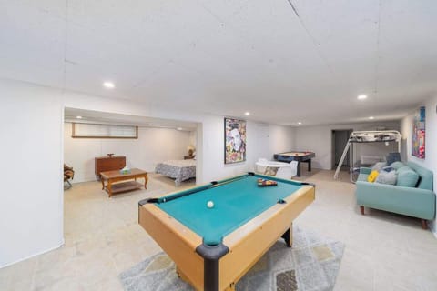 Spacious basement den with sleeping space and entertainment nearby.