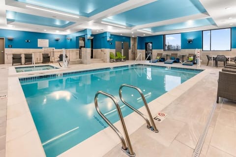 Dive into a sparkling indoor pool under calming skylit ceilings.