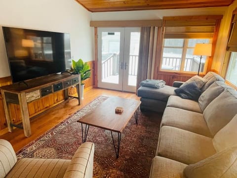 Living room with 78 inch screen TV