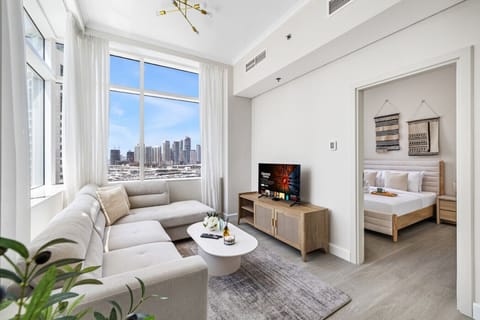 Bright living with cozy seating and smart TV for relaxing meals and movie nights.