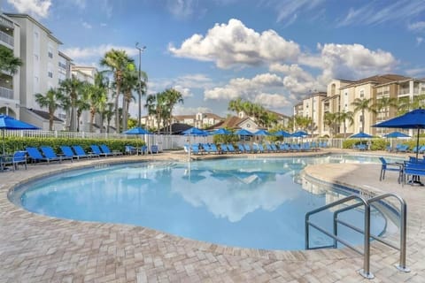 Stretch out by the serene pool under bright blue skies.