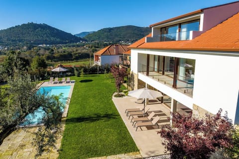 View of the pool and front of the house