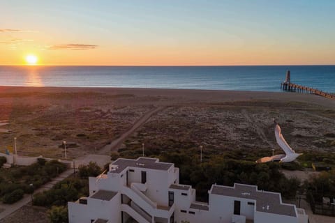 Golden hour over the Leucate coastline — 16 km of fine sandy beach unfold right at the edge of the residence.
