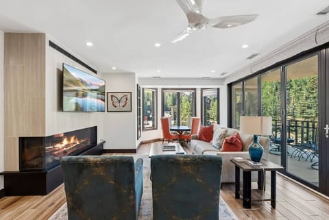 Living room with glass panel fireplace, smart tv, and spectacular views
