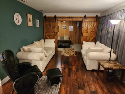 The larger white couch has the bed.