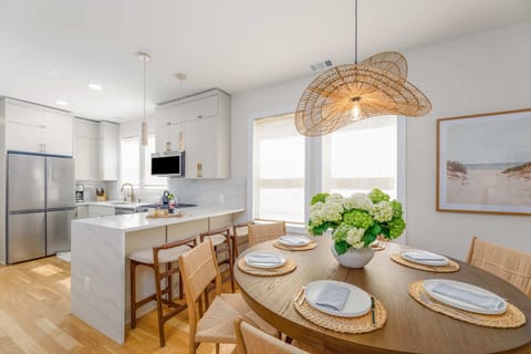 Welcome into the bright, open dining space! You can sit right here at the designer table under the statement light, or pull up a stool at our beautiful peninsula with quartz waterfall.  Enjoy your stay in Ventnor!