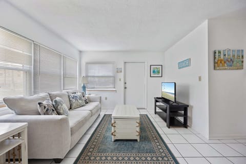 Bright living room with coastal-themed decor and comfortable seating.