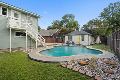 Unheated Pool, sun loungers, and fully fenced backyard with Detached Studio and exterior staircase access. Private outdoor space for up to 10 guests in northwest Dallas.
