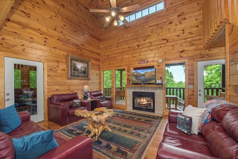 Warm knotty pine walls and soaring ceilings create your cozy mountain retreat. Relax in plush leather seating by the glowing fireplace or step onto your private deck to breathe in the forest views.
