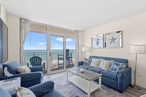 Blue accent pillows dress the sofa in this gorgeous oceanfront living room, framed by stunning panoramic views of the North Myrtle Beach shoreline.