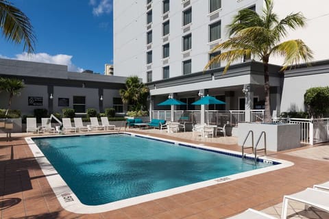 Dive into sunshine with loungers and a sparkling pool deck.