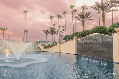 Soak in sunset serenity beside the sparkling fountain pool.