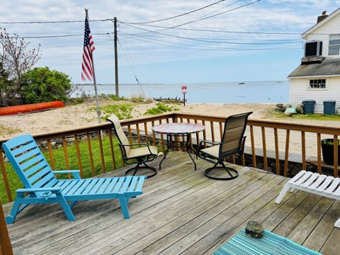 Front deck seating literally steps from Coral Sands beach!