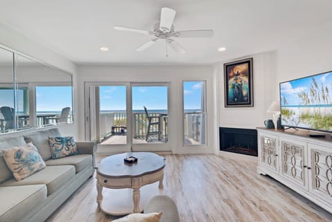 Bright coastal living room with private balcony and stunning ocean views