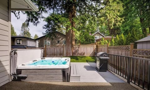 Outdoor Retreat: Relax in the hot tub or fire up the grill surrounded by lush greenery!