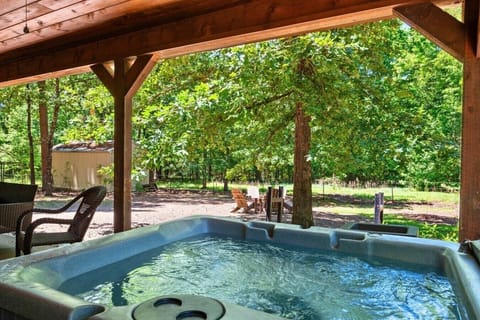 Relax in the private covered hot tub surrounded by peaceful forest views and outdoor seating area