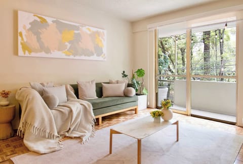 Flooded with natural light, the living room is the perfect place to ease into your day with coffee or unwind after exploring Condesa's vibrant streets.