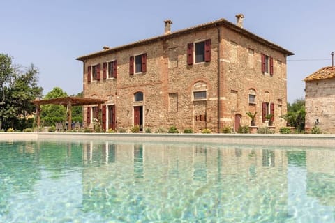 The view of the villa from the Pergola and terrace around the swimming pool