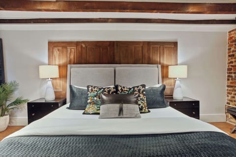 Bedroom 1 | King Bed and Daybed with Trundle with Brick Wall Detail | Garden Level — Unit on One Level