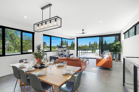Sunlit living and dining with panoramic views and seamless balcony access.