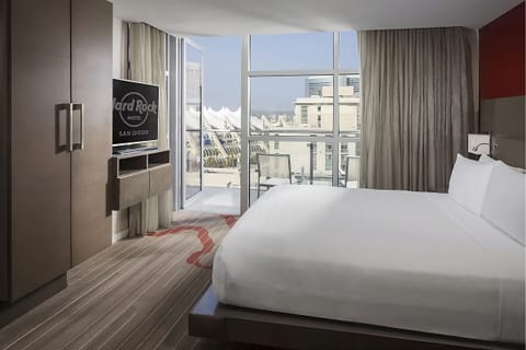 Wake up to sunlit views from bed and private balcony.