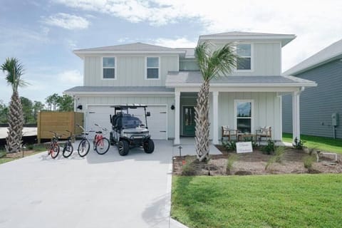 2 story home with 2 living rooms, screen porch, Golf cart and Bikes included