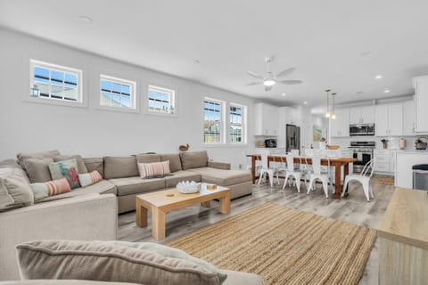 Bright open-concept living space with large sectional and modern kitchen