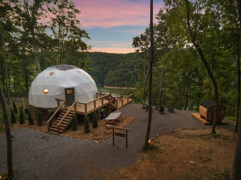Lakeview geodesic dome with deck, fire pit lounge area, and private sauna