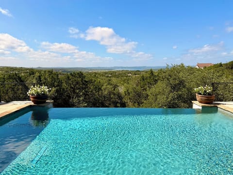 Infinity pool with sweeping hill country views and peaceful retreat vibes