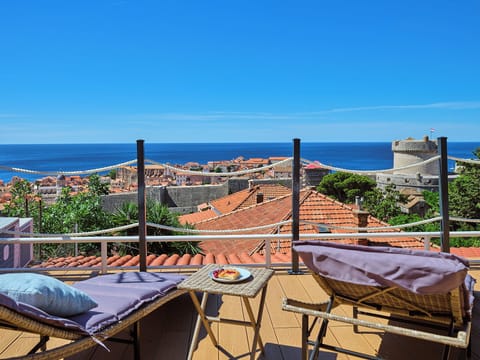 Relax on plush loungers atop this private terrace. Marvel at panoramic views of Dubrovnik's historic walls and the azure sea.