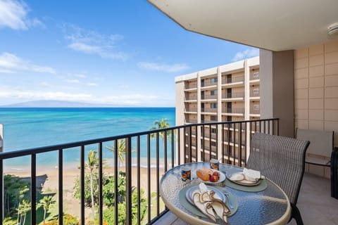 Ocean-view lanai with bistro dining set, ideal for meals by the sea.