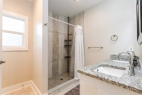 Refresh in this clean, modern bathroom featuring a convenient shower.