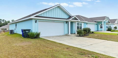 Charming coastal retreat just minutes from the beach. Spacious driveway and welcoming front porch set the tone for your family getaway.