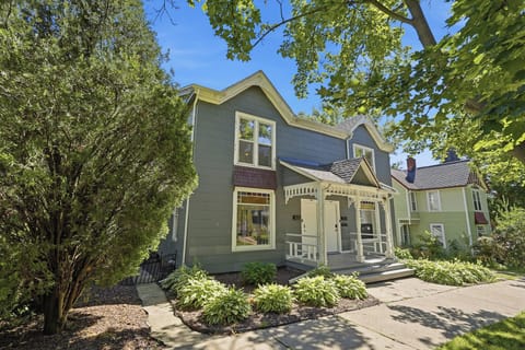 Charming tree-lined home with inviting porch and beautiful curb appeal

