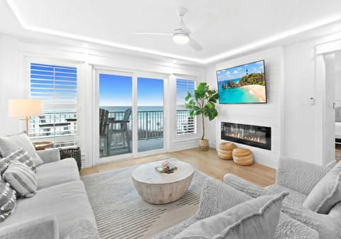 Living room: 65" Smart TV, electric fireplace, beach view, balcony