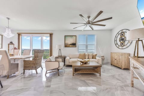 Bright living room with modern furnishings and a balcony view of the outdoors.