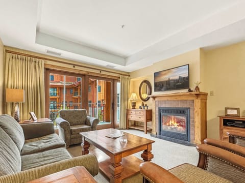 Cozy living room with gas fireplace, smart tv and access to your private large balcony | Listed with @BookTraverse