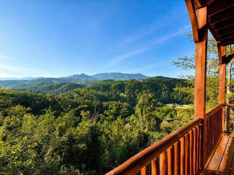 Covered deck with panoramic Smoky Mountain views, perfect for morning coffee and relaxing at our Gatlinburg cabin.