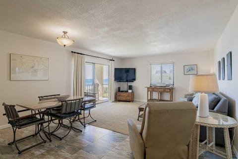 Spacious living and dining area with cozy seating and natural light