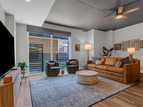 Living Room: Bright and inviting space with modern decor and sweeping views of downtown Knoxville!