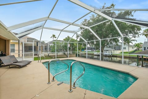 Private heated pool with canal views and plenty of space to relax after a day on the water.